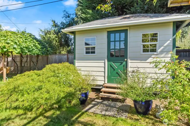 Adorable shed doubles as delightful view and convenient storage!
