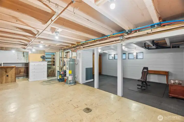 Beyond the water heater is the staircase down from the kitchen--the interior access to the basement.  As you can see, there is AMPLE space down here for a multitude of flexible options!