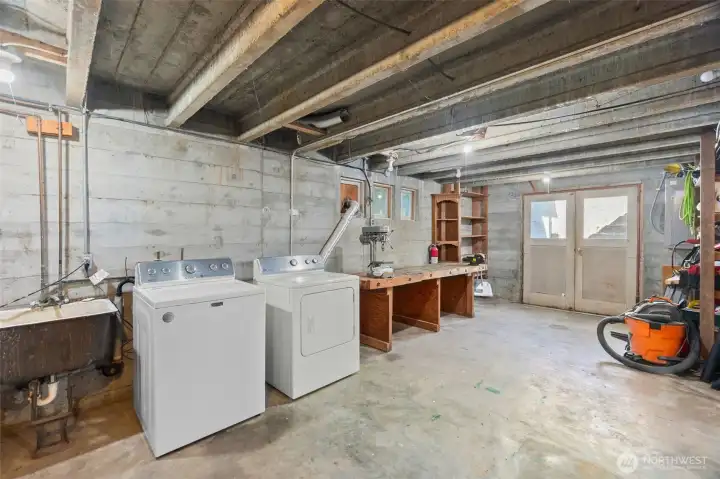 Washer and dryer are housed next to the utility sink, with more natural light here than just about any basement you'll encounter. These are the doors that go up to the backyard, which allow for easy transport of items in and out.
