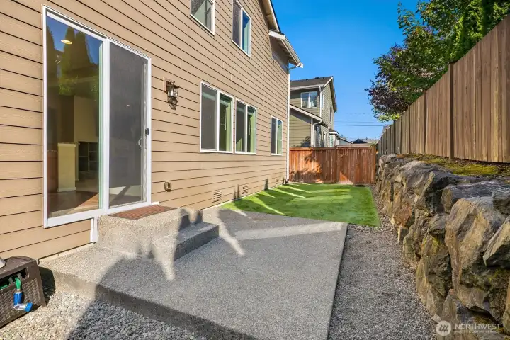 Patio area in the back with artificial turf. No mowing