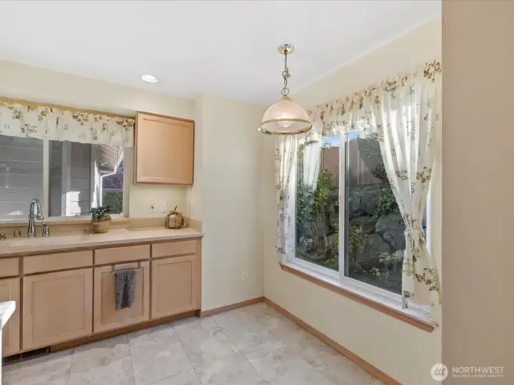 View of the kitchen dining space from the open concept dining room. Enjoy your sipping your morning coffee while enjoying the view of the yard.