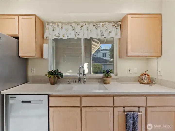 Large window over the sink looks out towards the entry & front lawn