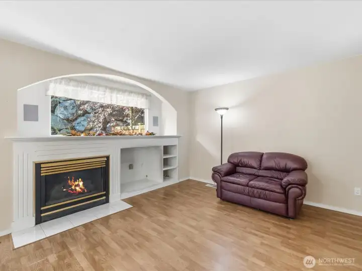 The open concept living & dining space is flooded with natural light & views of the patio & lush green backyard