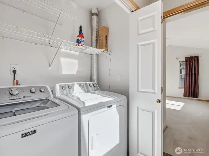 Laundry space is located in the hallway just outside the primary suite