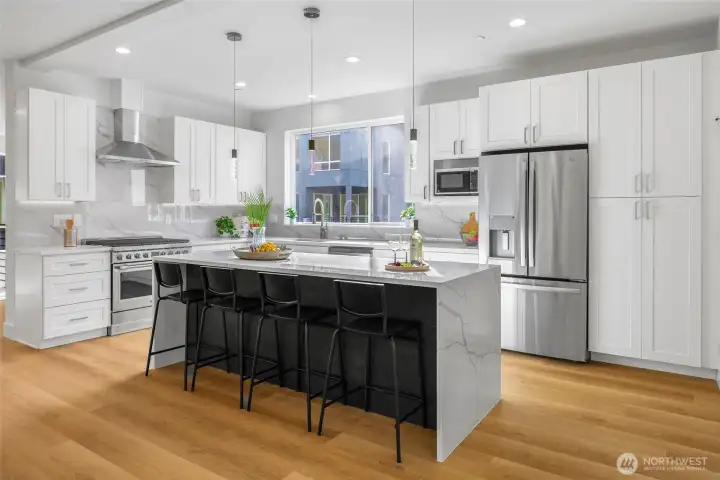 Spacious kitchen with island and bar seating.  Gas range and high end appliances.