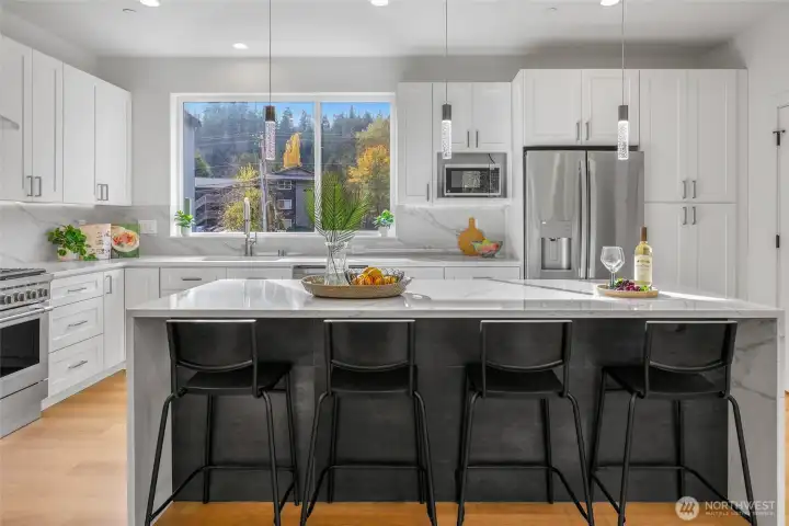 Spacious kitchen with island and bar seating.  Gas range and high end appliances.