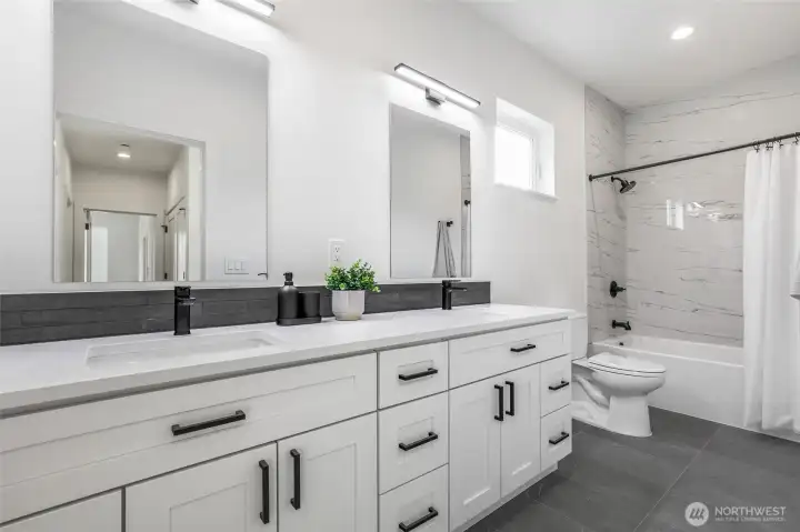 Third full bath with dual vanity.