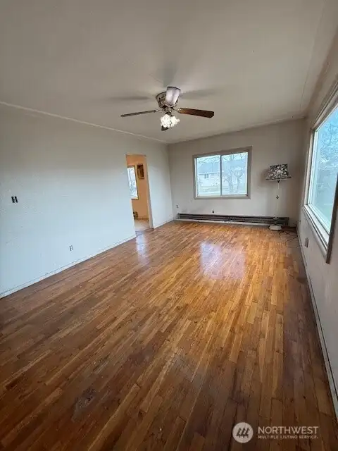 The entry to the left goes into the kitchen and dining space.  Imagine taking out the wall that now separates to open up the kitchen area to this living room.