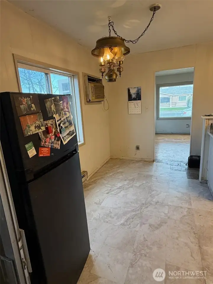 The dining area is to the left of the kitchen.  The chandelier is original vintage to match the home (very unique).