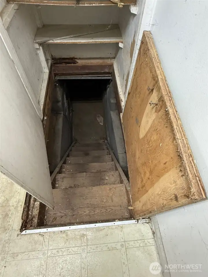 This leads down to a small basement space are (storage?) where the water heater in located.