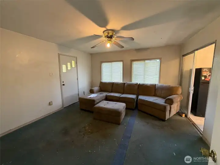 envision hardwood also in this family room or a new carpet.  The door to the left opens to the back yard and the detached garage/shop