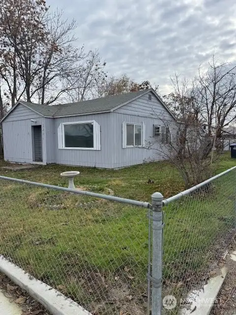 This fully fenced front and back is just waiting for a new owner's vision to add to its curb appeal.  Plenty of room for a garden too