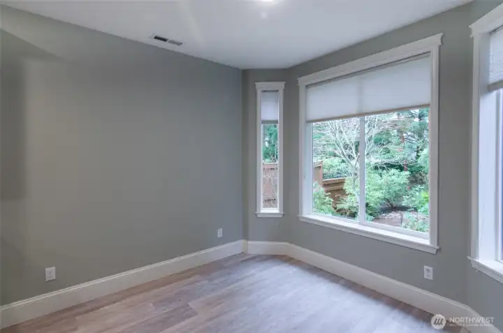 Open dining area off kitchen with bay window and door leading to back yard patio.