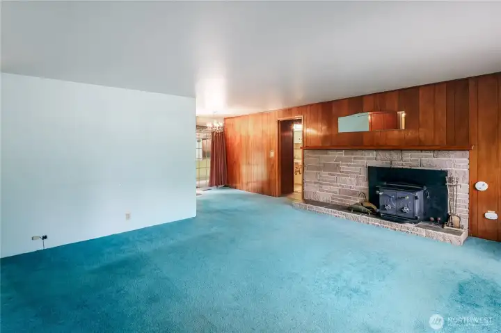 Large, double-sided wood fireplace with sandstone facia.