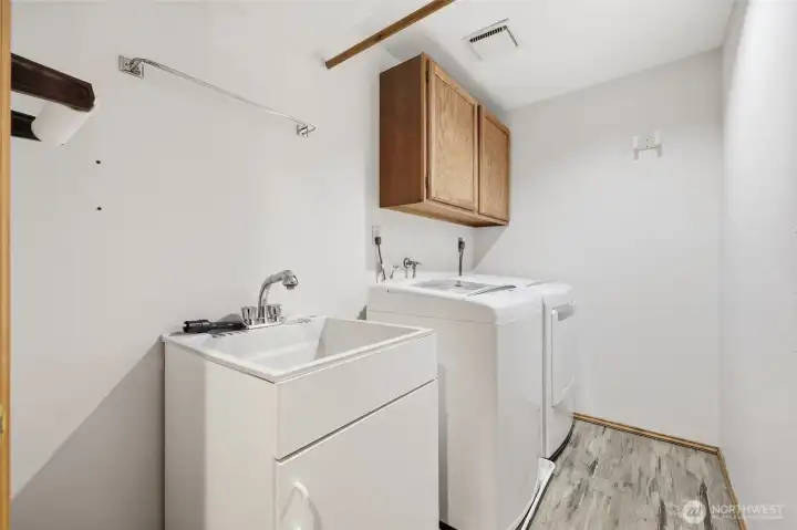 next to the powder room you have the wash room complete with a utility sink