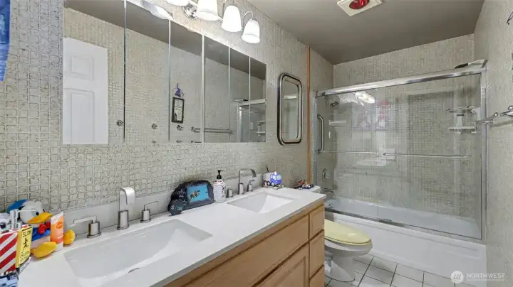 Upper-level bathroom with dual sinks and generous storage