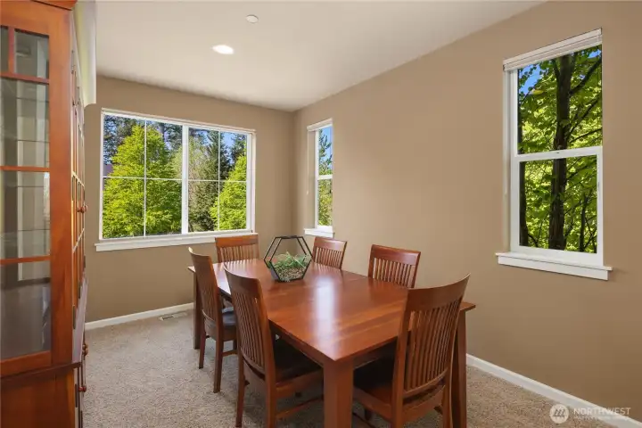 Formal dining room with lots of windows that invite the outdoors in.