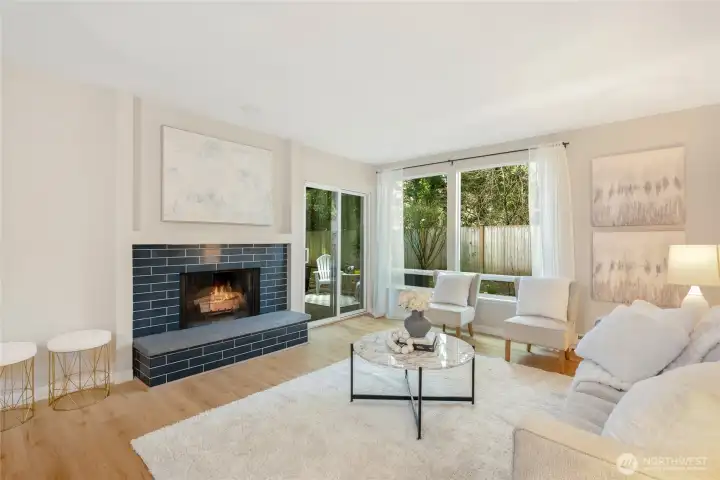 Gorgeous modern tile surround on the fireplace for cozy gatherings. Big bright windows and a sliding door to the private covered patio.