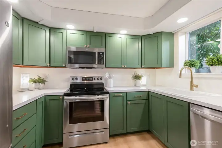It's basically a brand new kitchen! New trendy green kitchen with gold hardware and soft close, new stainless appliances, new sink  & faucet.