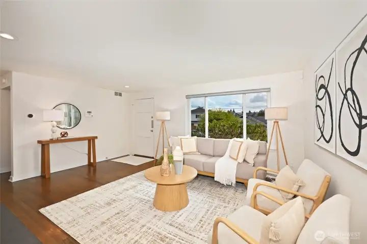 The living room windows have electric blinds controlled by a remote control for easy privacy.