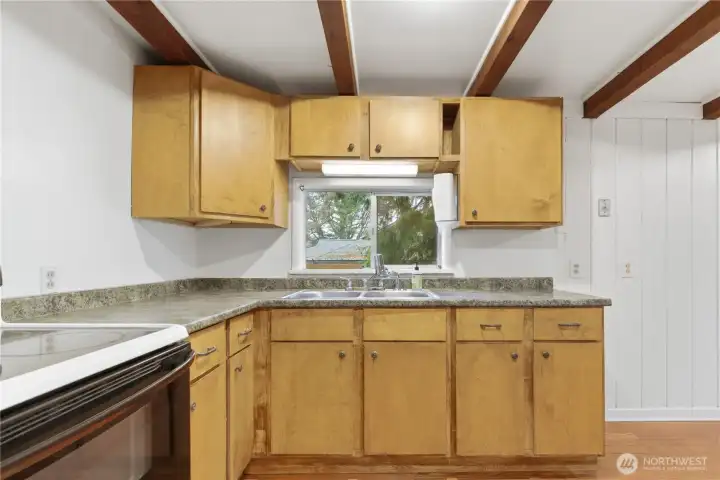 The kitchen offers generous cabinetry, providing ample storage for cookware, pantry items, and everyday essentials.