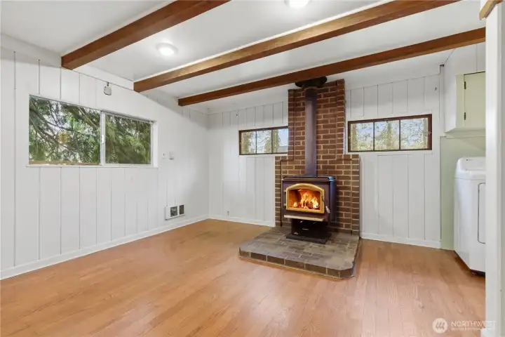 The dining area offers a warm, rustic feel centered around a charming fireplace.