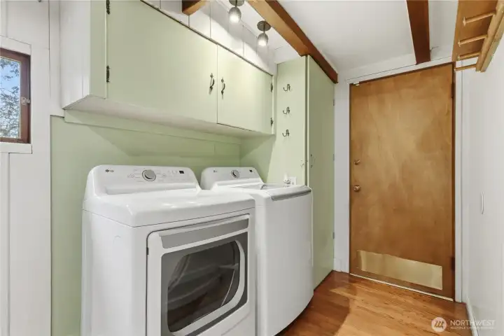 The laundry area is conveniently located and offers easy access for everyday tasks. Just beyond, the door leads out to the backyard, creating a seamless connection between indoor living and outdoor space.