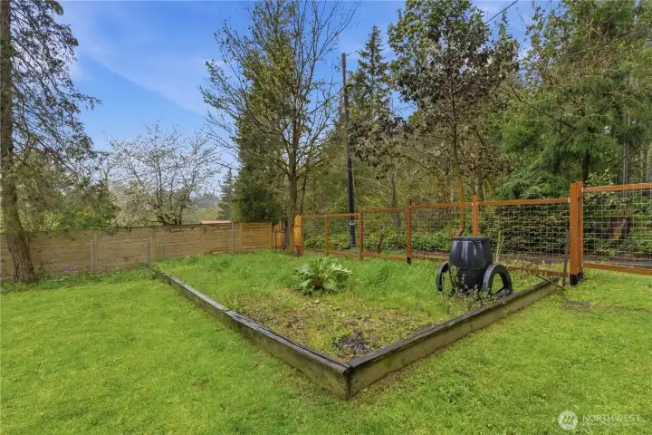 Raised garden beds are in place and ready for your plantings, offering an easy way to grow flowers, herbs, or vegetables in a well-organized and manageable space.
