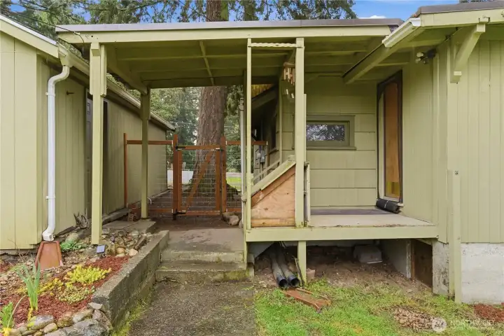 This photo shows the back door to the home, offering convenient access between the interior, backyard and garage for easy everyday living.