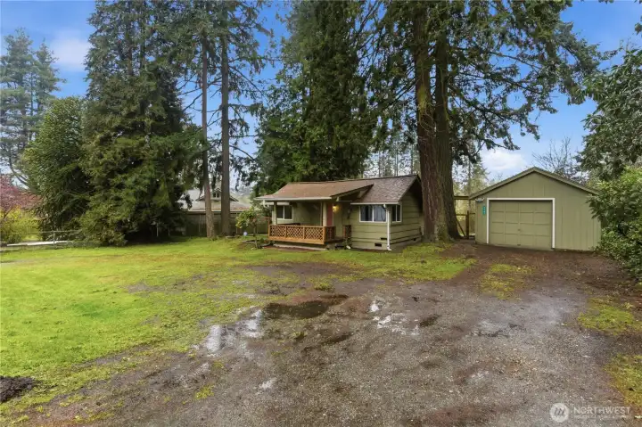 The home is set back from the road, providing a bit of separation from passing traffic while still offering easy access for commuting and everyday convenience.