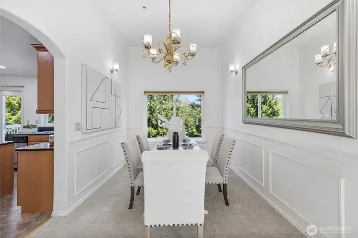 Formal dining room with arched door way to the kitchen.