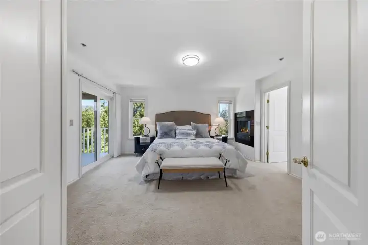 Primary bedroom with sliding door to private balcony.