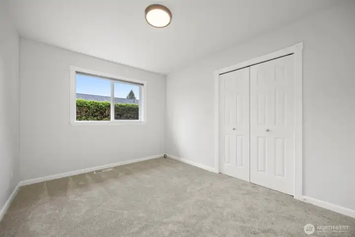 View of the third bedroom at the back of the house, facing the backyard. View of the third bedroom at the back of the house, facing the backyard.