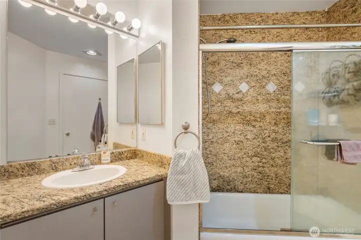 Full bath with granite finishes and generous vanity space