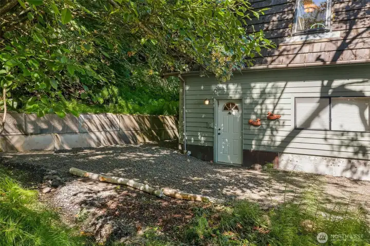 Upper level living quarters are accessed from the side door or through the garage/workshop. Plenty of parking in front and along this side.