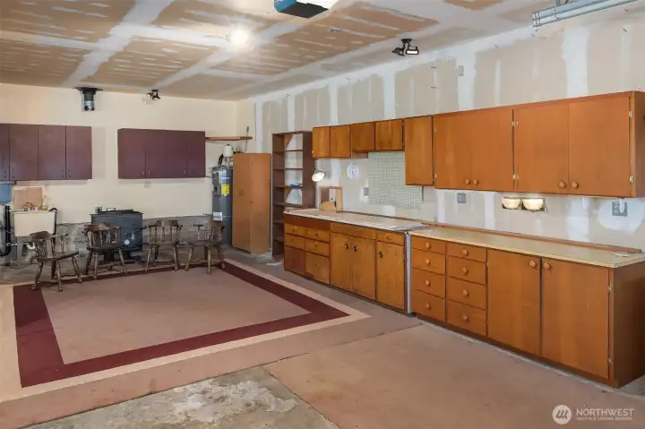 Remove the wall cabinet above the wood stove, hook up the stove pipe, and this becomes an even better hang-out, games or projects space.