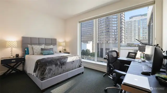 Guest bedroom/office with more of the floor to ceiling windows to enjoy the dramatic city views.