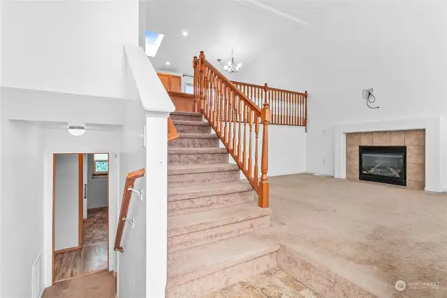 Split level entry with a mother-in-law suite/separate apartment down the stairs equipped with a full kitchen and shared laundry area, large living room to the right and the kitchen, dining room 3 bedrooms and a guest bathroom upstairs