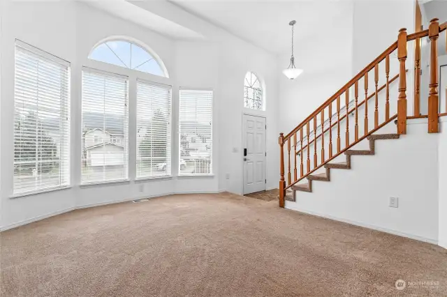 Lots of natural light comes into this inviting living room with vaulted ceilings