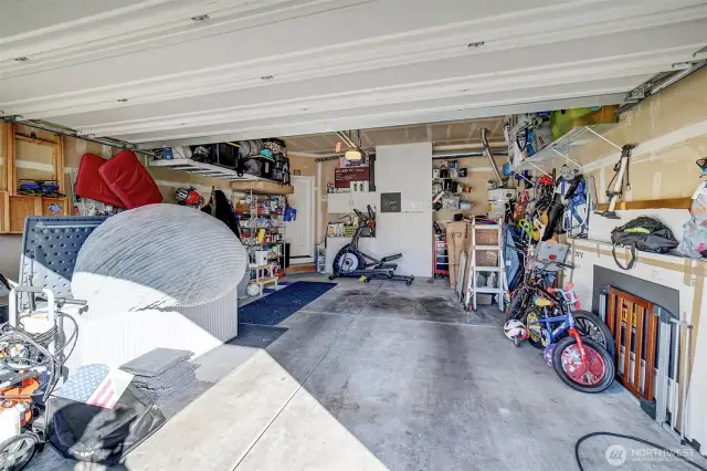 Two car garage with EV charger and storage space