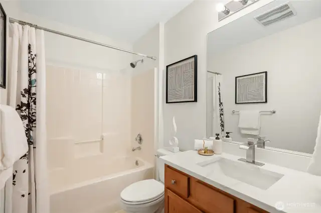 Full bath with tub/shower combo.