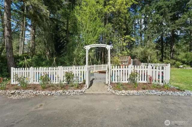 Fenced garden with raised beds, irrigation, lighting and green house with power.