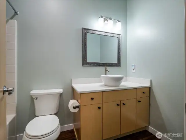 The main bathroom has been updated with quartz countertops and vessel sink.