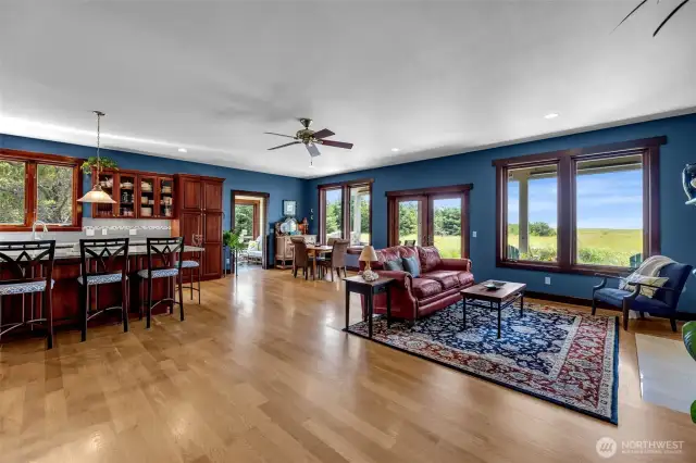 Expansive open plan ocean view great room with access to covered porch and sunroom