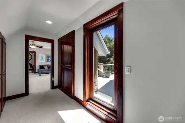 Hallway from top of stairs, generous closets, doors to east deck and big bonus room.