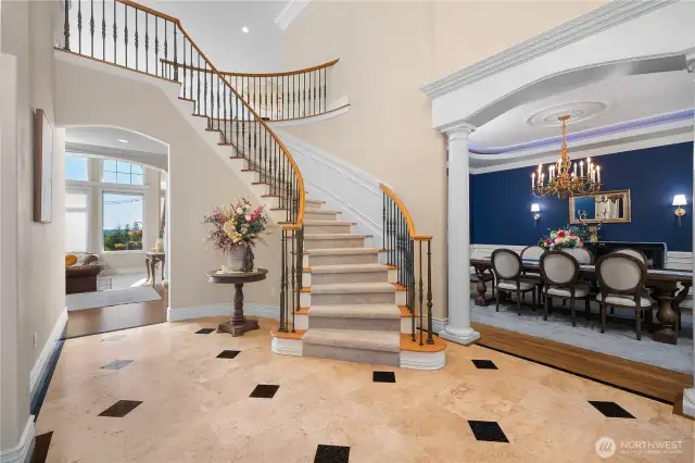 Grand entry with Office/Library to the left and elegant dining to the right.