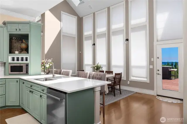 French doors off kitchen and family room lead to a 2100 sq ft deck with outdoor kitchen and dining, Struxere Awning with auto close and heating, patio, in-ground pool and outdoor shower.