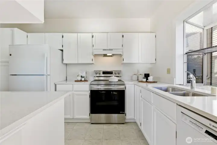 Refreshed kitchen featuring sleek quartz countertops and updated cabinetry.