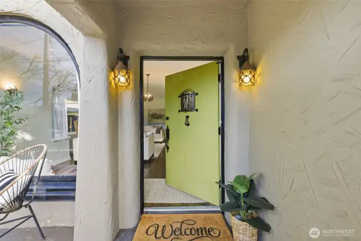 Most of the original features of the home are intact, including the wrought iron encased window in the entry door.