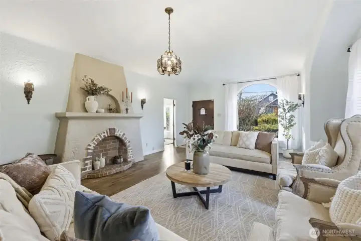 The magnificent fireplace, now an artistic masterpiece, anchors the living room.